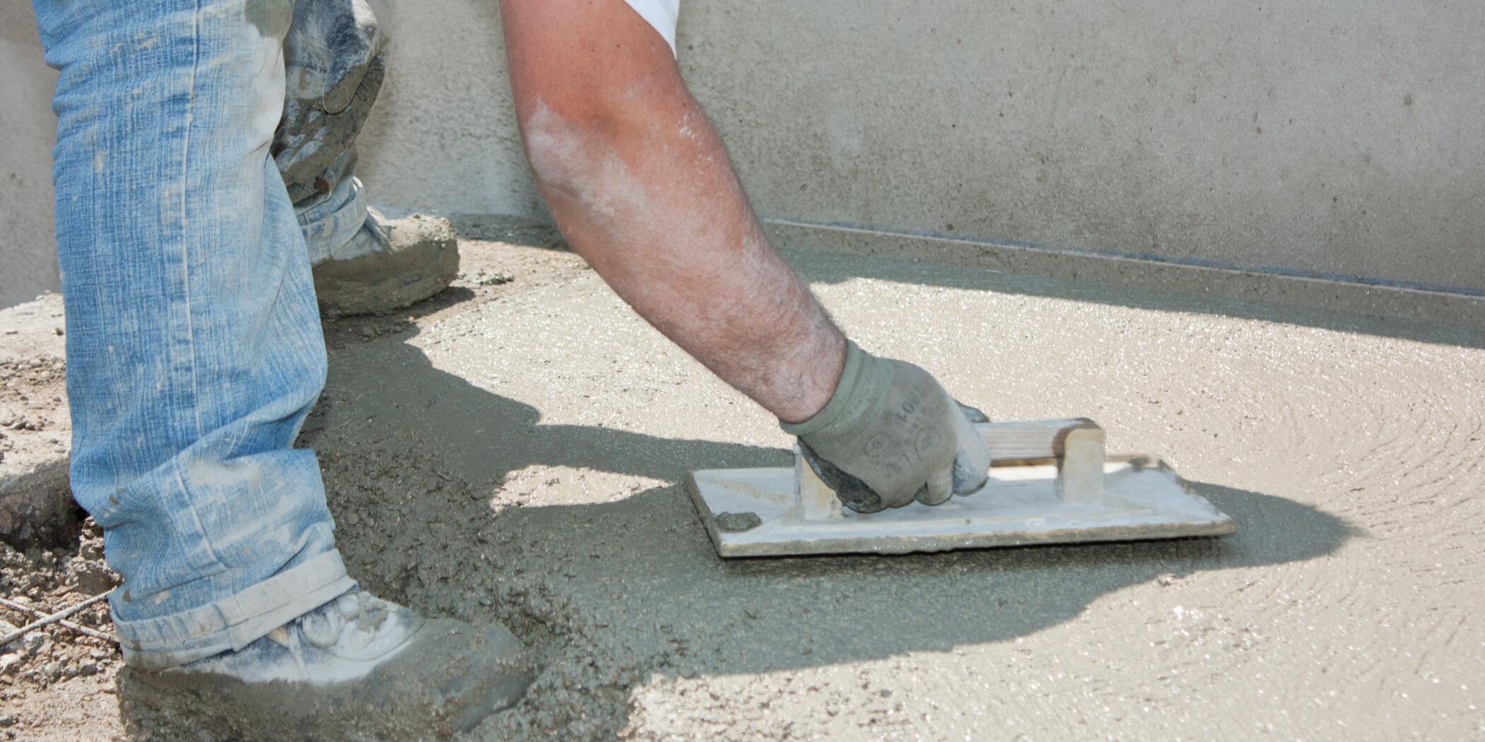 man resurfacing the concrete flooring